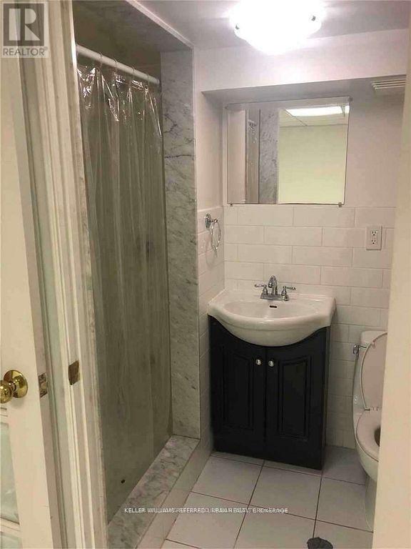 A bathroom with a sink, toilet and shower.