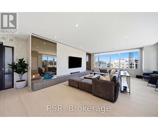 A modern living room with a large couch and a flat screen TV.