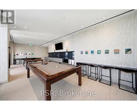 A pool table in a room with a bar area.