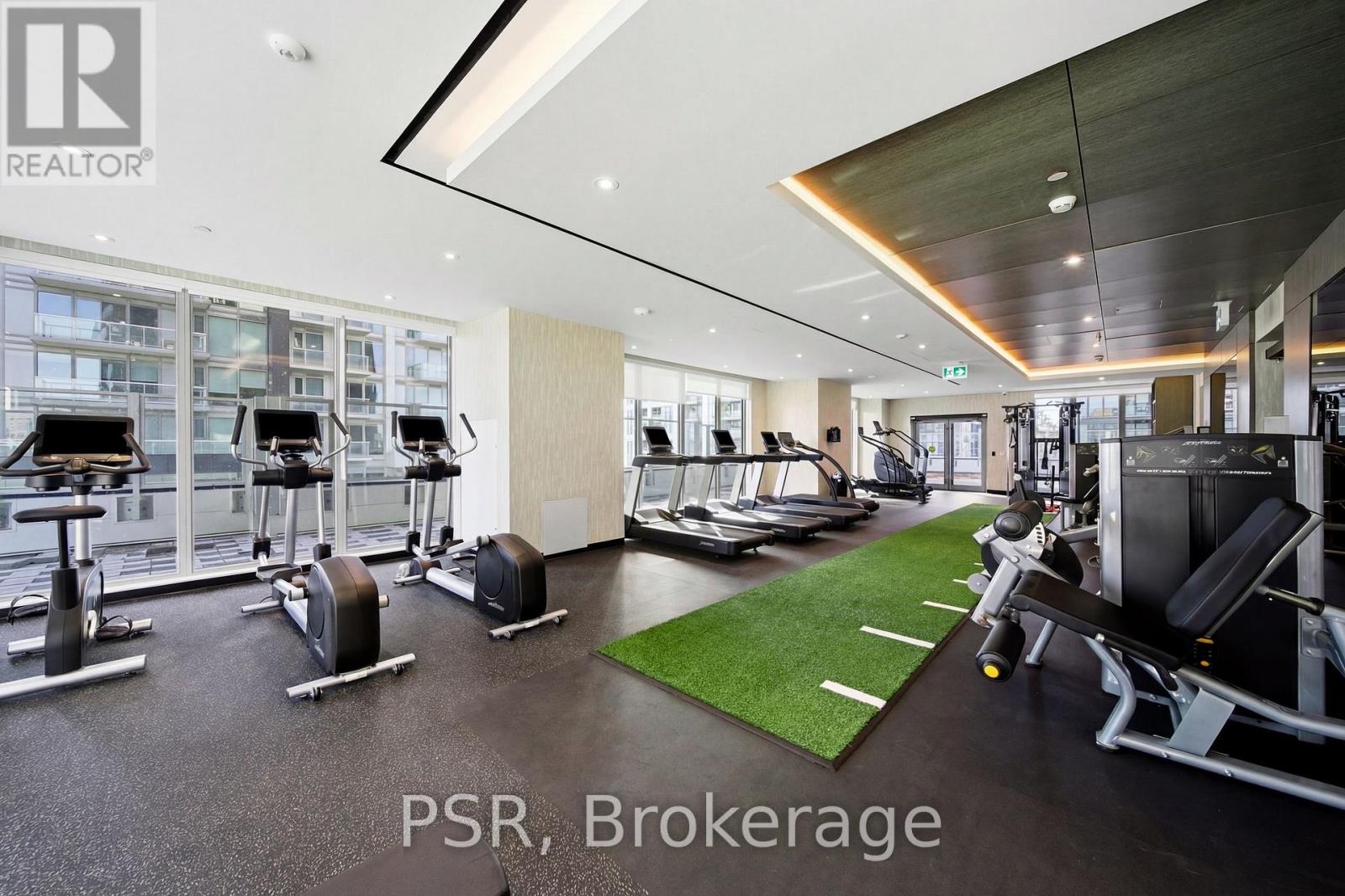 A gym with a variety of equipment including treadmills, weights, and a bench press.