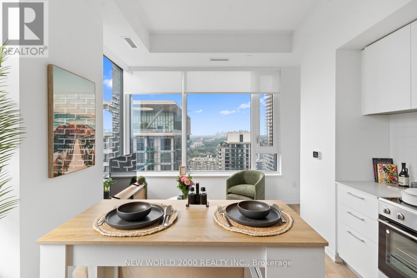 A modern kitchen with a dining table set for two.