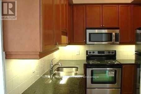A kitchen with a stove top oven and microwave.