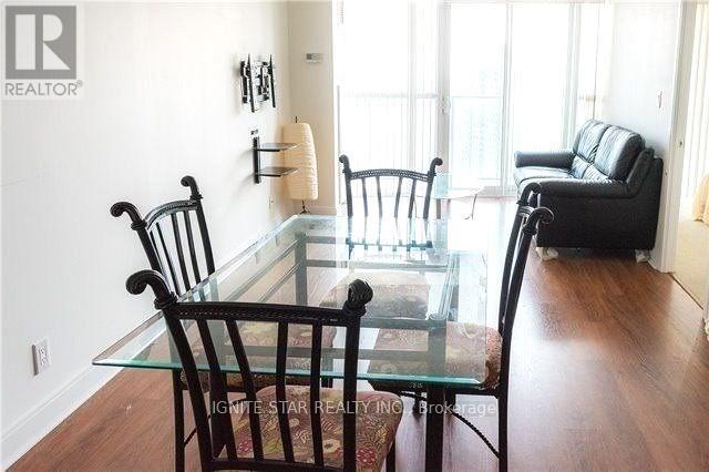 A dining room with a glass table and chairs.