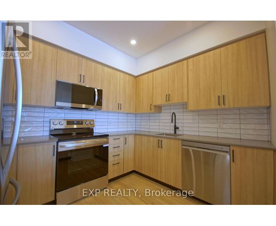 A kitchen with wooden cabinets and a stainless steel oven.