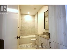 A bathroom with a toilet, sink, and mirror.