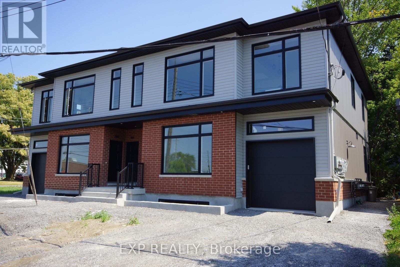 A two-story house with a garage is for sale.