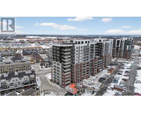A cityscape with a mix of modern and older buildings, with snow on the ground and a clear sky.