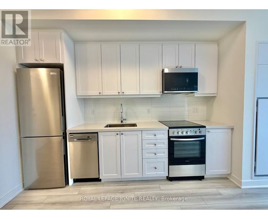 A kitchen with white cabinets and appliances.