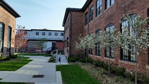 A brick building with a walkway in front of it.