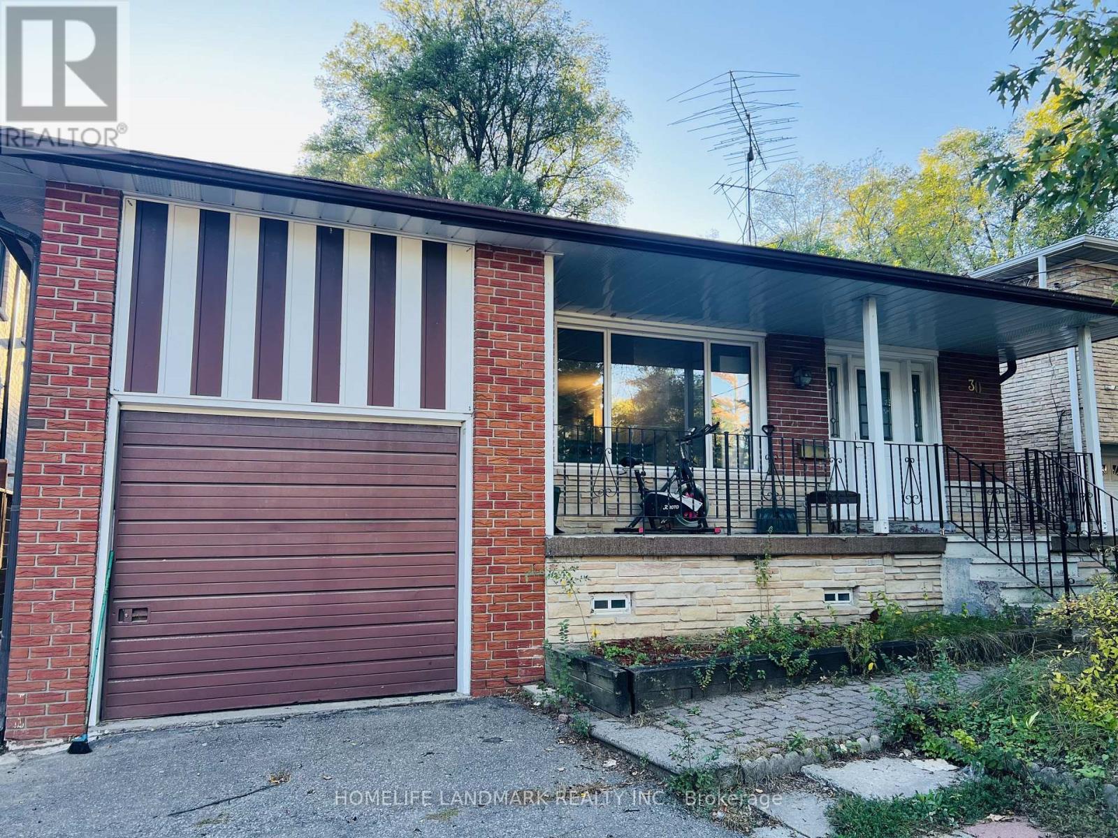 A red brick house with a closed brown garage door.