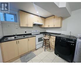 A kitchen with black countertops and wooden cabinets.
