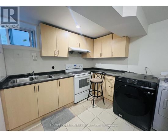 A kitchen with black countertops and wooden cabinets.