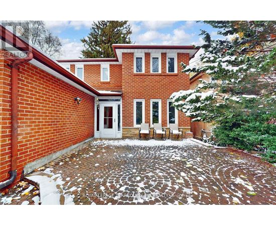 A red brick house with a white door and windows.