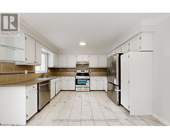 A kitchen with white cabinets and appliances.