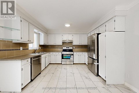 A kitchen with white cabinets and appliances.