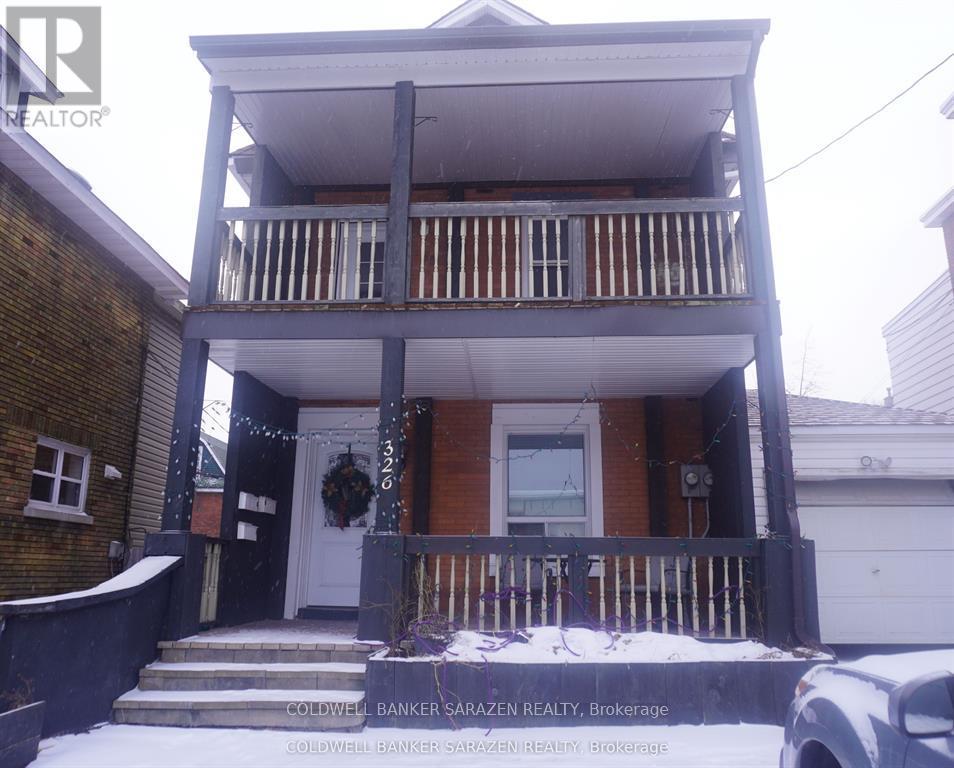 A two-story house with a balcony and a garage.