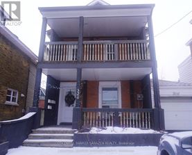 A two-story house with a balcony and a garage.