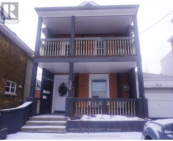 A two-story house with a balcony and a garage.