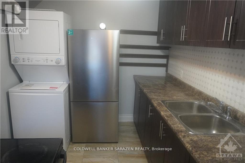 A kitchen with a stainless steel refrigerator and a white refrigerator freezer.