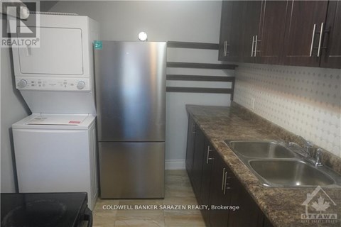 A kitchen with a stainless steel refrigerator and a white refrigerator freezer.