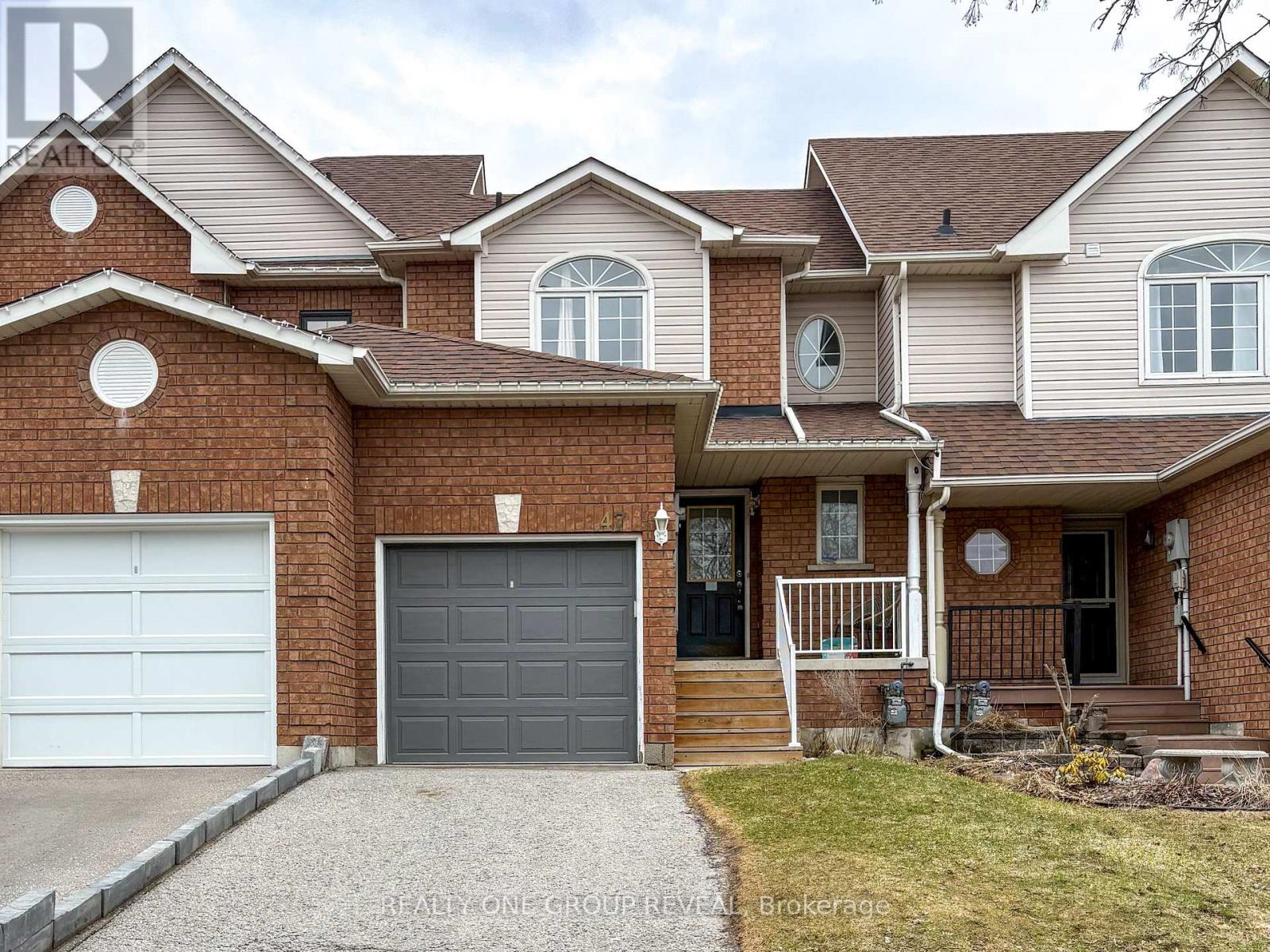 A house with a brick facade and a grey garage door.
