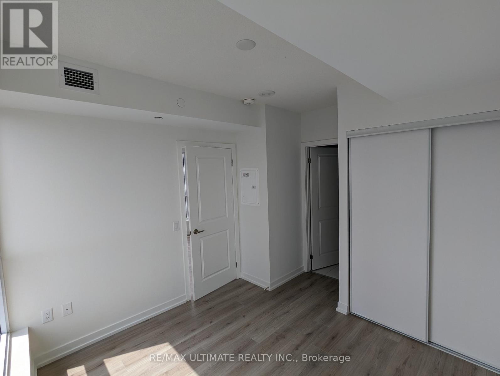 A room with a white wall and a door.