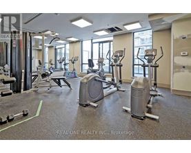 A gym with a variety of equipment including treadmills, weights, and exercise machines.
