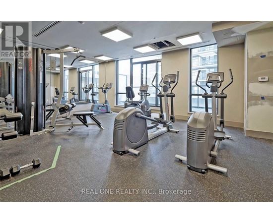 A gym with a variety of equipment including treadmills, weights, and exercise machines.