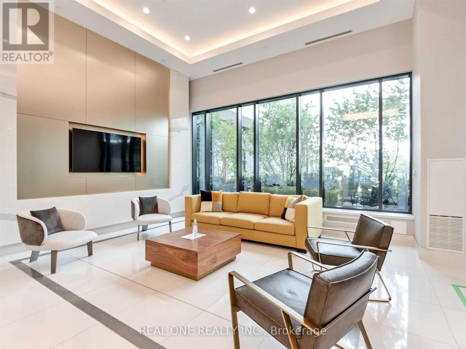 A living room with a large couch, a television, and a coffee table.