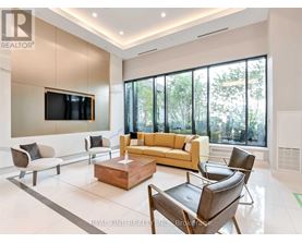A living room with a large couch, a television, and a coffee table.