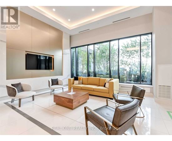A living room with a large couch, a television, and a coffee table.