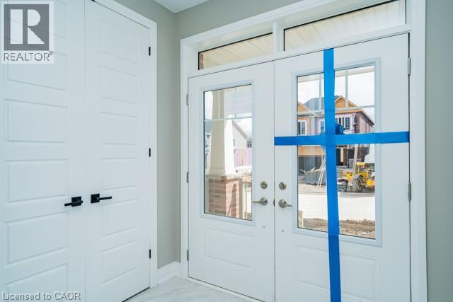A white door with a blue tape across it.