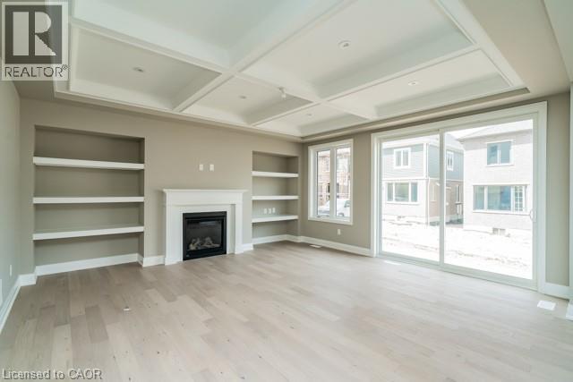 A spacious living room with a fireplace and built-in shelves.