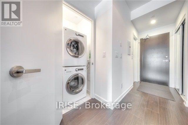 A brokerage sign is on the wall of a hallway.