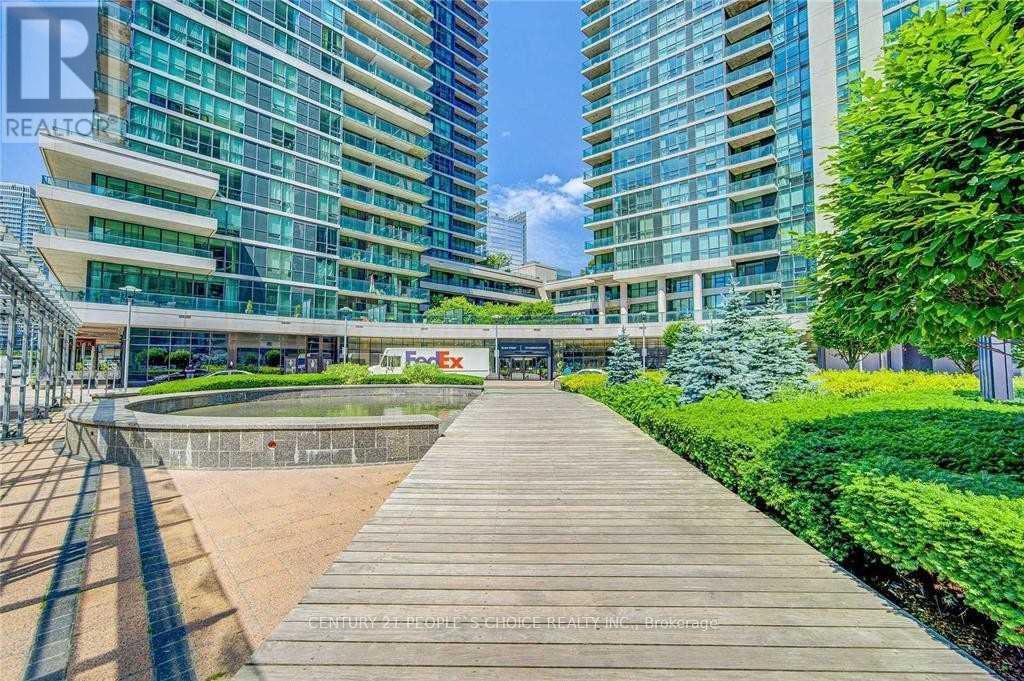 A wooden walkway leads to a building with a blue sky in the background.