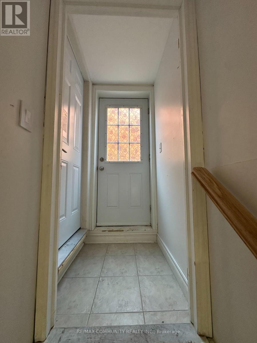 A hallway with a door and a window.