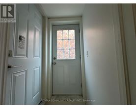 A hallway with a door and a window.