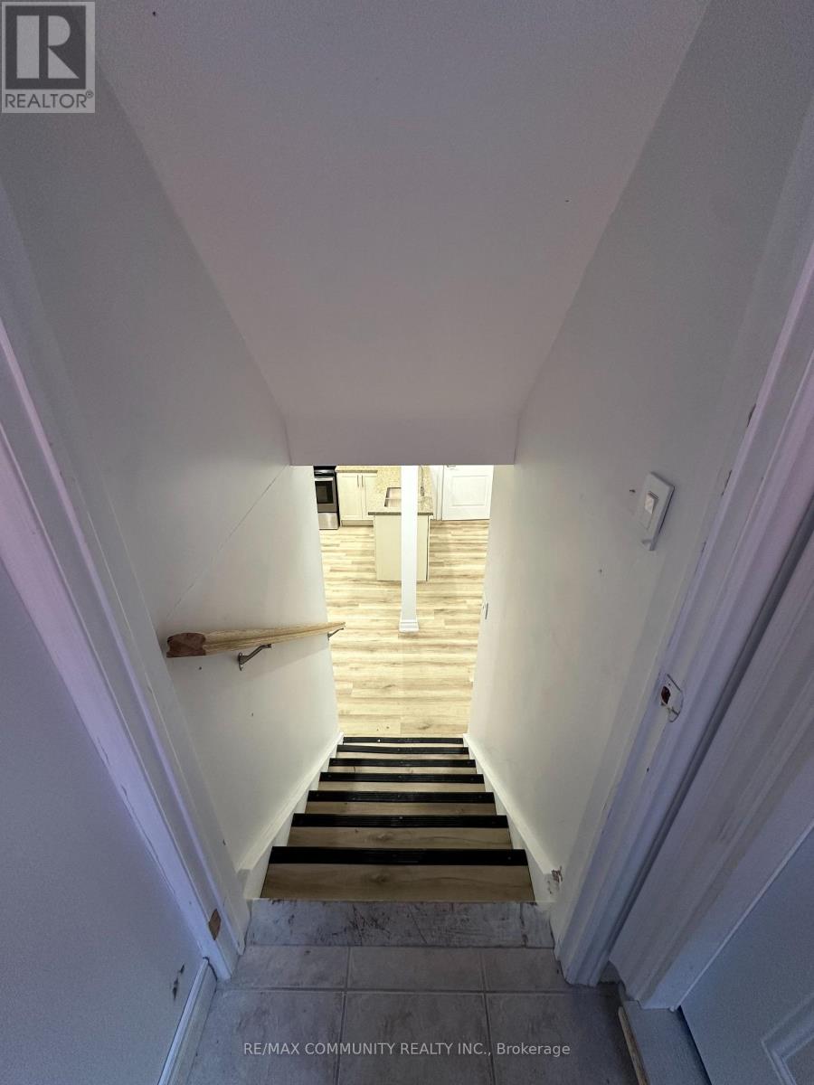 A stairway leading to a doorway with a light on.