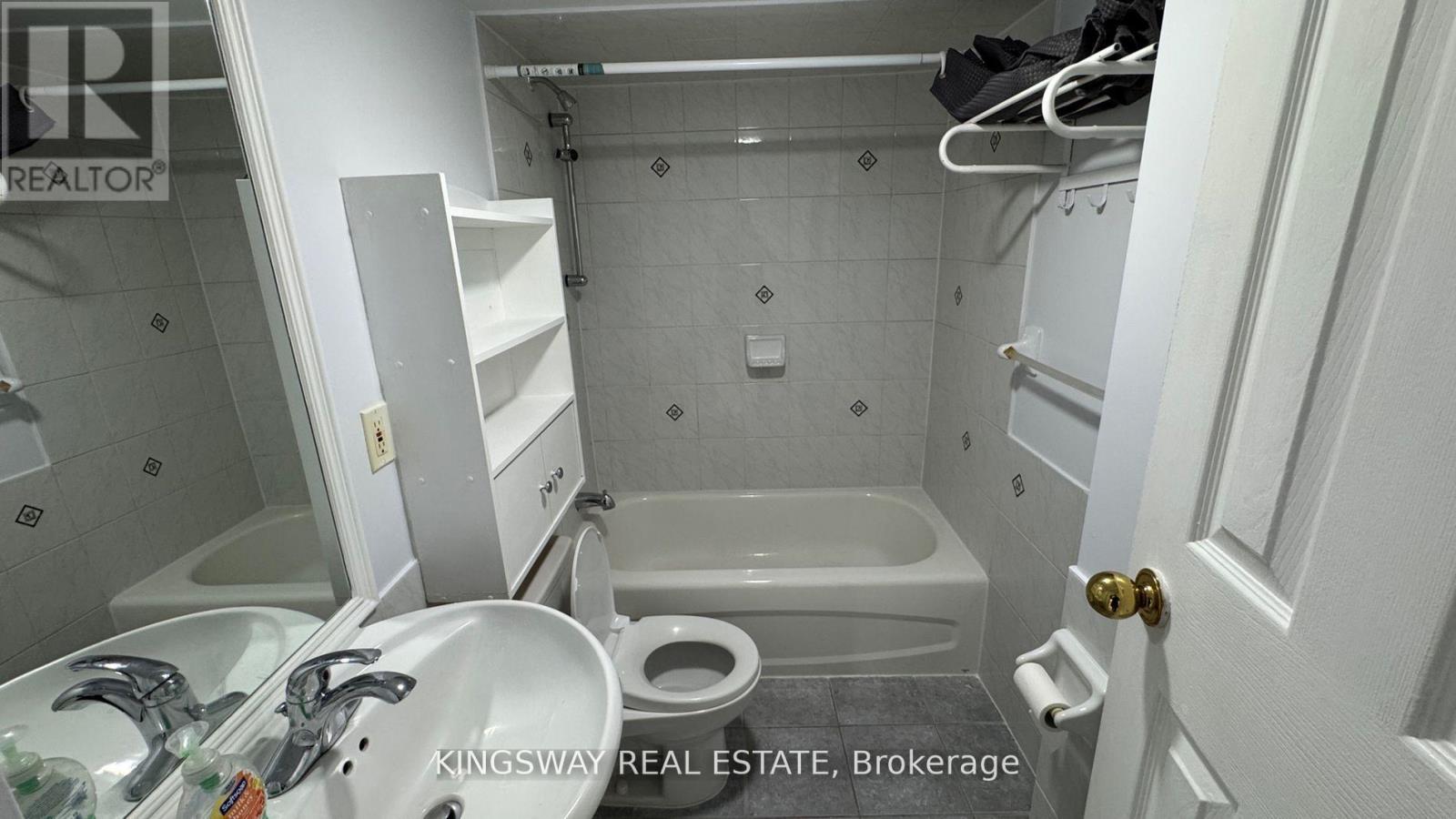 A white bathroom with a toilet, sink, and bathtub.