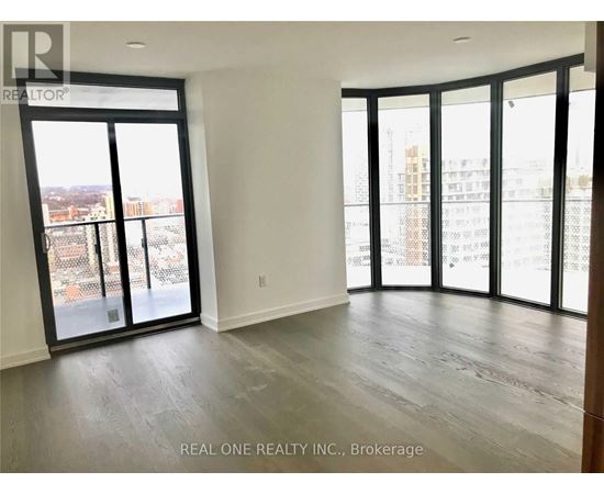 A spacious room with large windows and sliding glass doors.