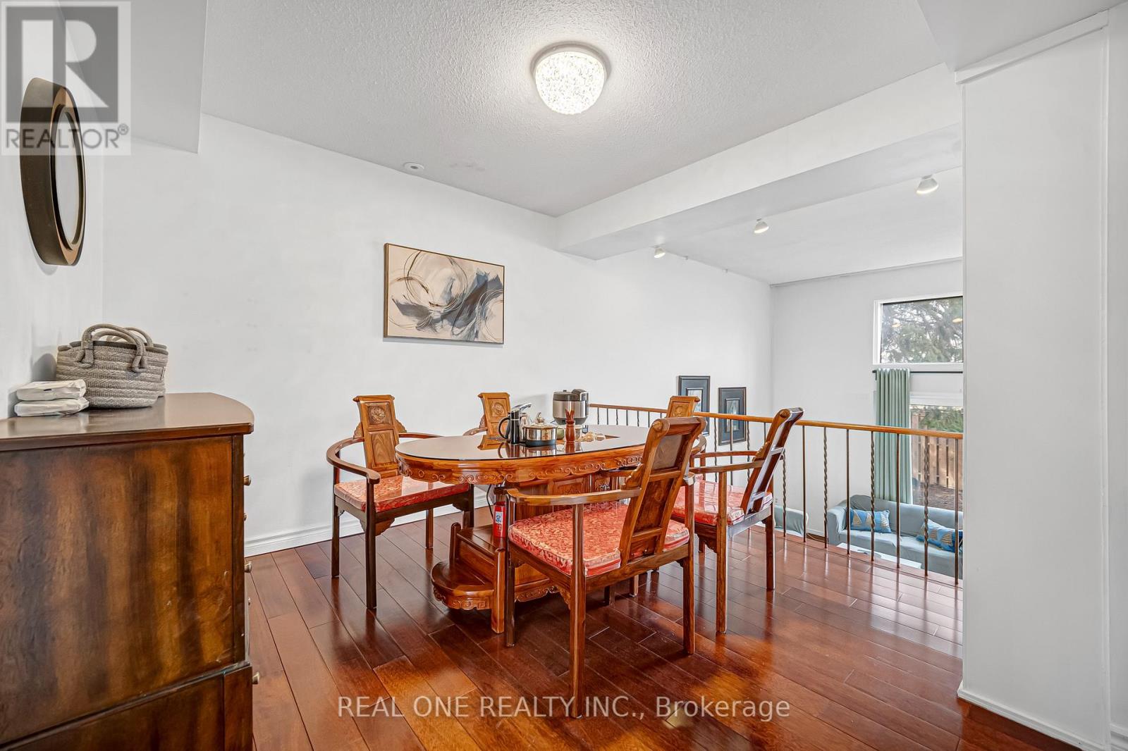 A dining room with a wooden table and chairs.