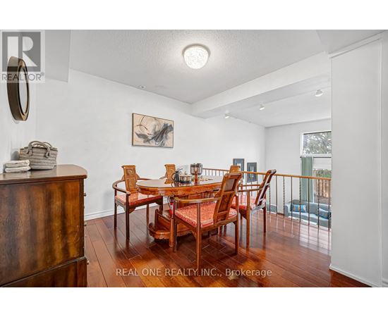 A dining room with a wooden table and chairs.