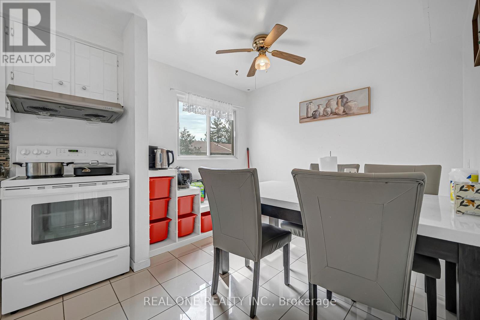 A white kitchen with a table and chairs.