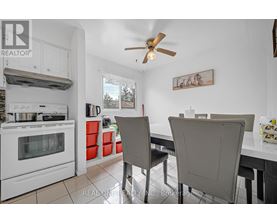 A white kitchen with a table and chairs.