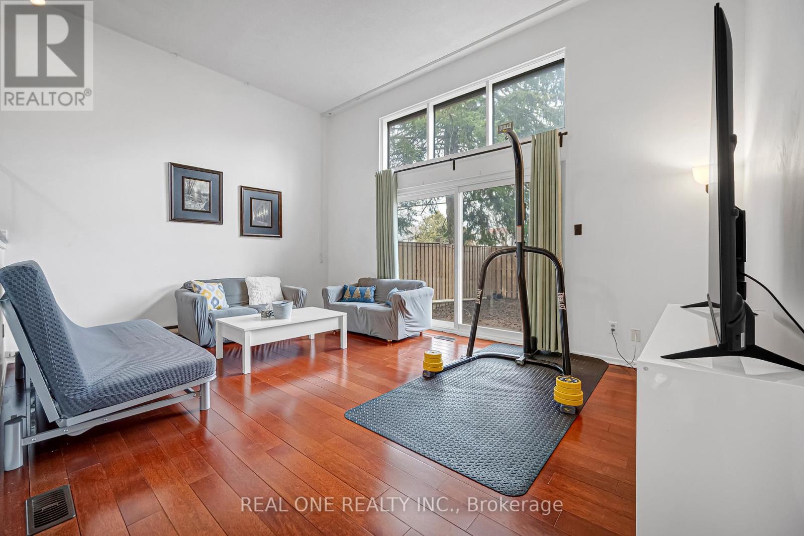 A living room with a grey chair and a white sofa.