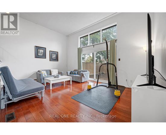 A living room with a grey chair and a white sofa.