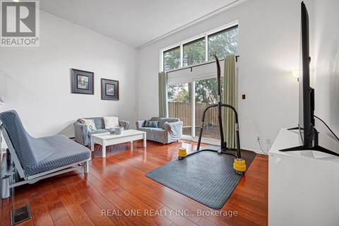 A living room with a grey chair and a white sofa.