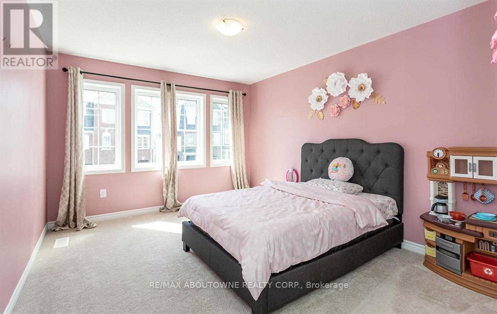 A bedroom with a large bed and a window with curtains.