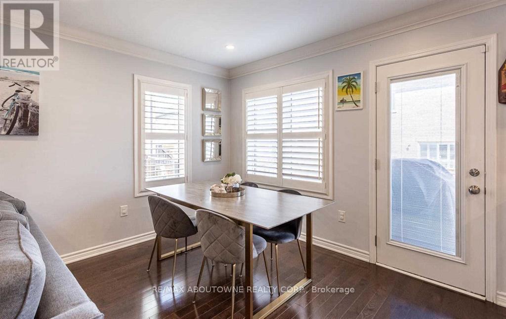 A dining room with a table and chairs.