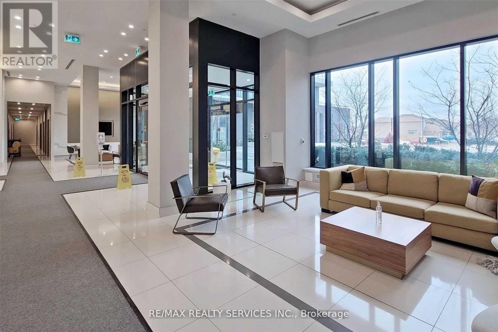 A spacious lobby area with a reception desk and comfortable seating.